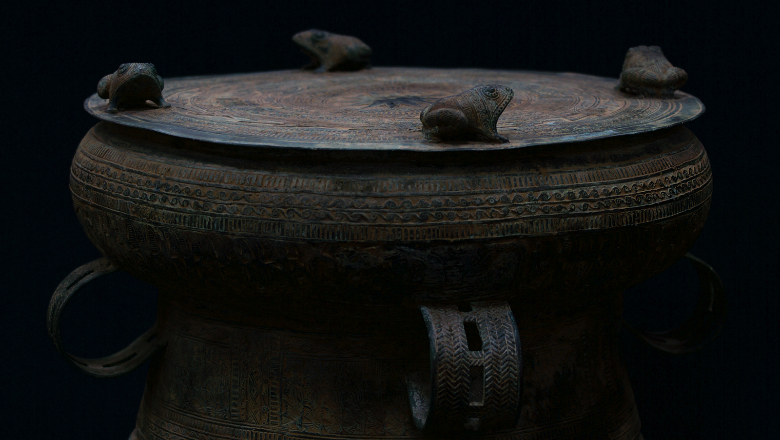 ReSounding Play STEMS Page side image of ancient bronze drum with decorative frogs by James Nguyen