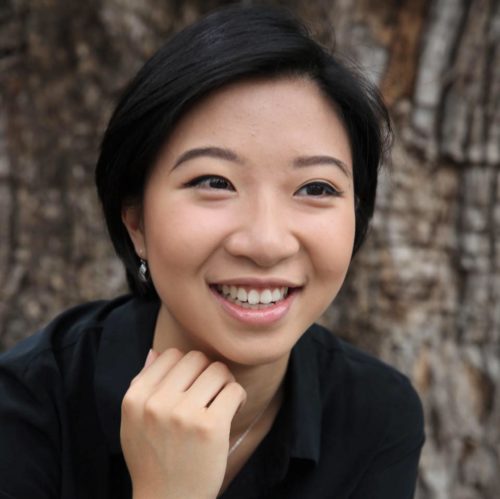 Victoria Pham Headshot Victoria smiling with short black hair and hand under her chin