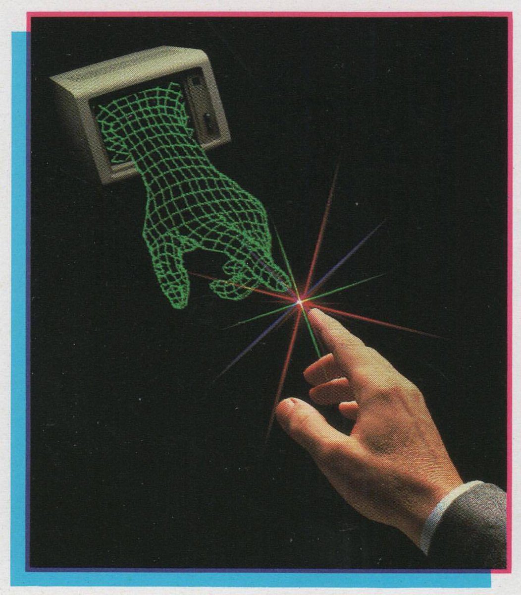 A three-dimensional, green wireframe hand protrudes from a vintage computer monitor, and a human hand interacts with it by touching its fingertips, causing a visual effect of multicolored lines emanating from the point of contact.